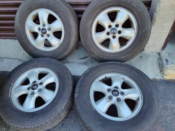 Original 16 inch aluminum Hyundai wheels with old tires - Montebello, Los Angeles, California